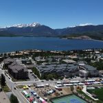 Drone overview of La Riva Condos with park in the forground and the Lake and Mountains behind